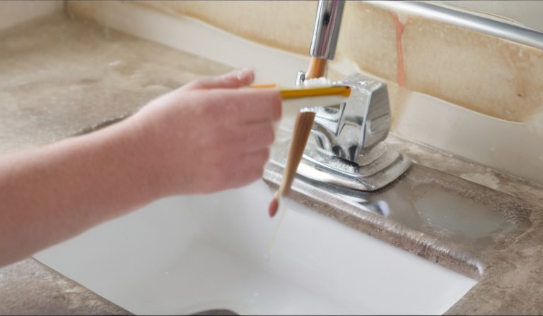 Is it safe to wash paint brushes in the sink?